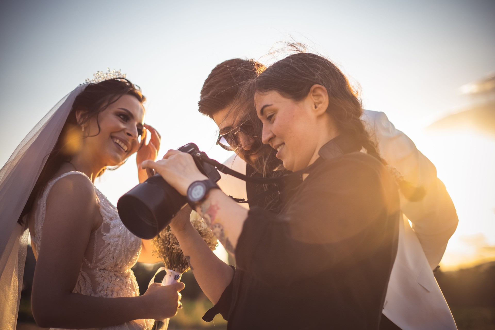 Wedding photographer showing the photos to the couple