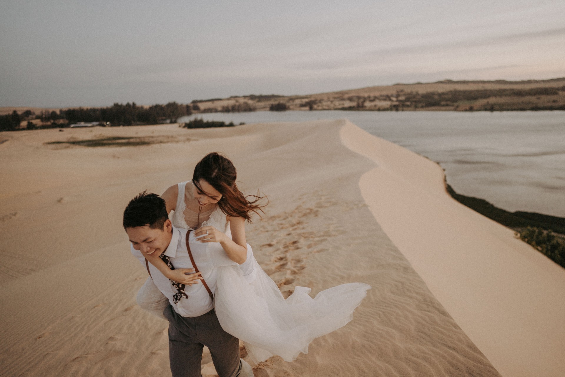 Asian Bride and groom, desert elopement, holding hands, walking, moving forward