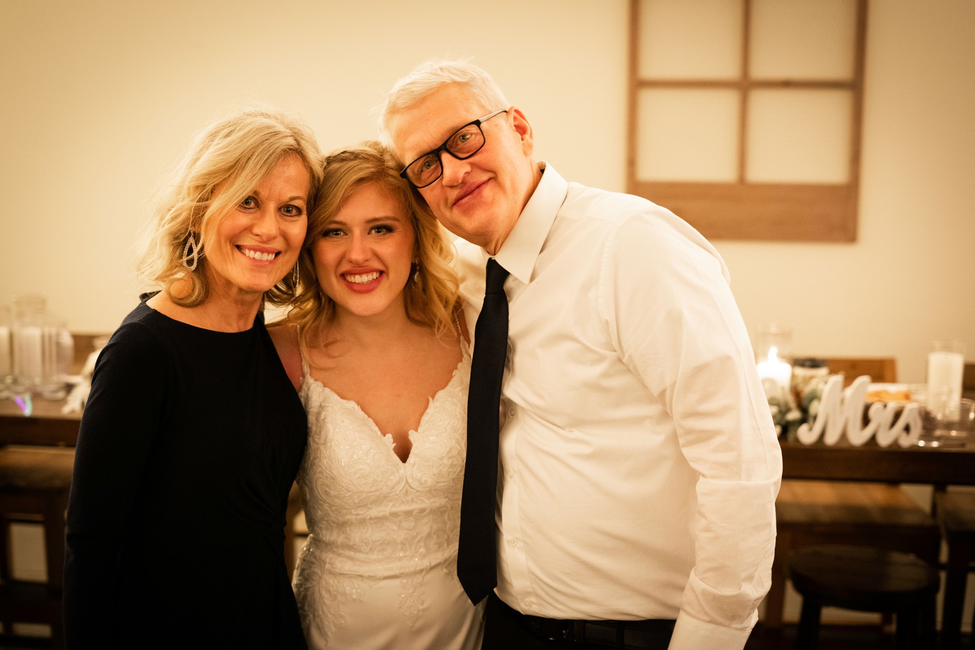 Smiling blond bride with adult parents